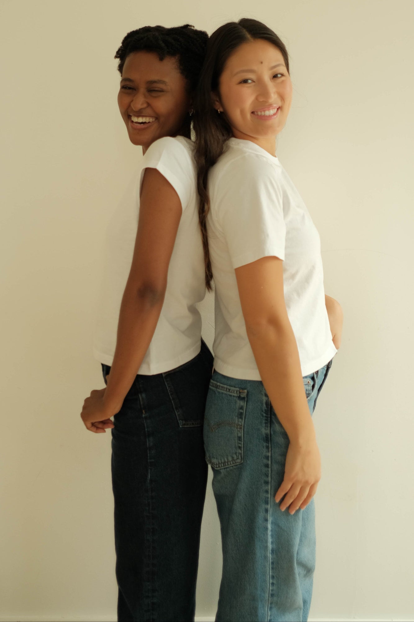 two woman wearing perfect white t shirts